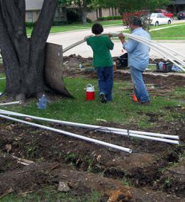 two of our techs are arranging the pipes for the new sprinkler system