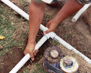Jack, one of our Cambridge irrigation repair pros, is assembling the pvc pipes on a new sprinkler installation